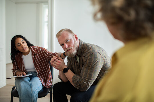 Man being supported during group therapy discussion
