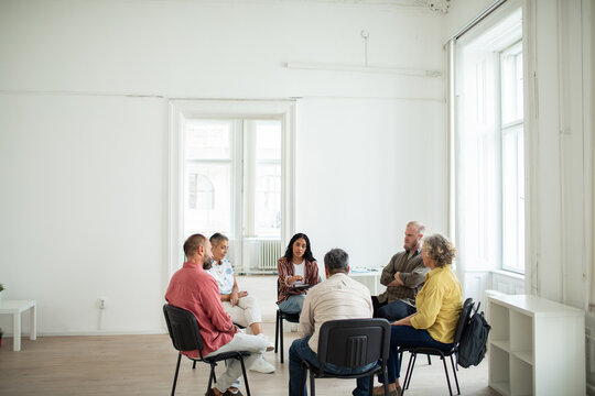 Group therapy session with multiple people