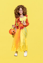 Cute curly girl in a costume for autumn and Halloween