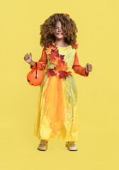 Cute curly girl in a costume for autumn and Halloween