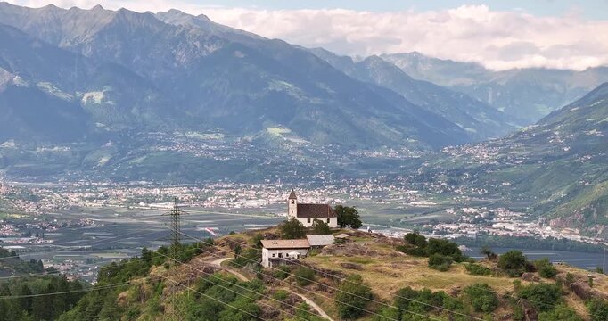 Drone view over Etschtal toward Merano with St Hippolyt church