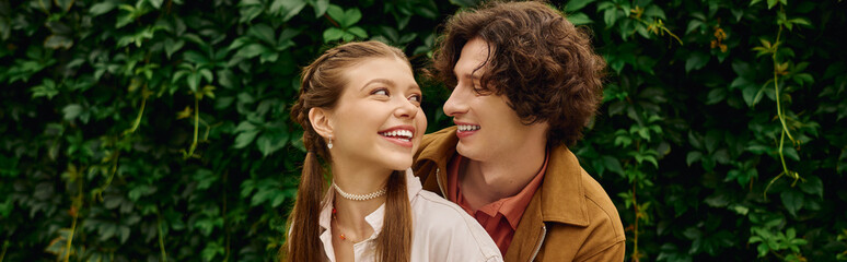 Loving couple enjoys a joyful walk in the park surrounded by lush greenery and blissful moments