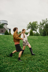 Fototapeta premium Joyful couple enjoying a romantic stroll in the park during a blissful day outdoors