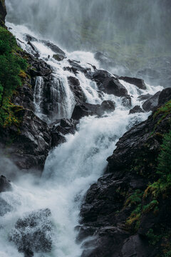 L&aring;tefossen Waterfall in Norway with a misty atmosphere