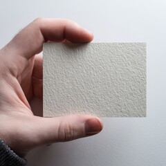 Hand Holding Blank Textured White Card