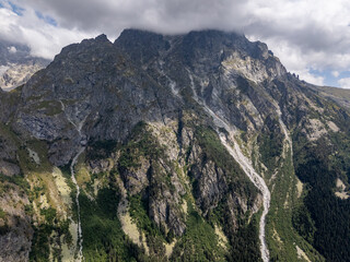 Aerial view of rocky mountains covered by clouds in Mestia, Svaneti, Georgia