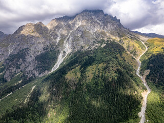Aerial view of rocky mountains covered by clouds in Mestia, Svaneti, Georgia