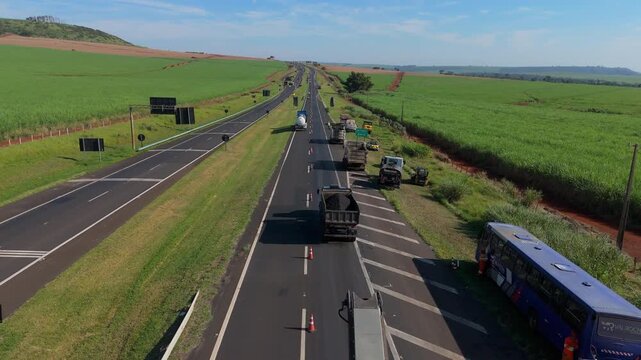 Workers Operating Machinery Applying Asphalt on Road Construction