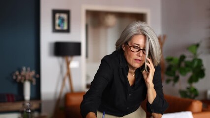Businesswoman working from home and making a phone call - Powered by Adobe