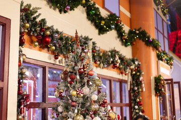 Several Christmas trees adorned with ornaments and lights brighten the evening atmosphere of a festive event shop inviting people to gather and celebrate