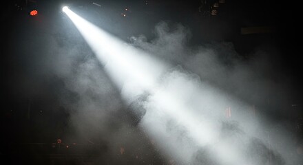 Bright White Spotlight Shining Through Smoke on Dark Stage