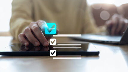 Digital productivity and task management concept with a person using a checklist app on a tablet, an online to-do list, business planning, project workflow, and time management technology.