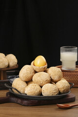 Free Range Golden Eggs with Coconut Coating and Milk Glass on Rustic Wooden Table