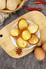 Traditional Yellow Coagulated Eggs with Asian Spices on Wooden Cutting Board Food Photography