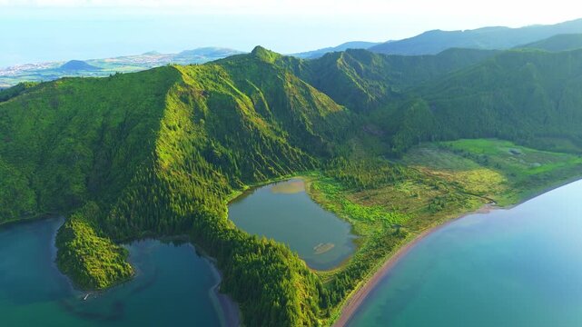 Lagoa do Fogo Lake on Sunny Morning. Green Lush Hills and Mountains. Azores, Sao Miguel Island. Portugal. Aerial View. Drone Moves Back