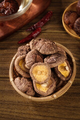 Fototapeta premium Dried Shiitake Mushrooms in Bamboo Basket - Asian Cooking Ingredients Still Life