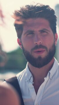 Young attractive man standing on the street talking with woman smiling laughing feel happy close up portrait city male outside love street handsomу shine sun sunset slow motion