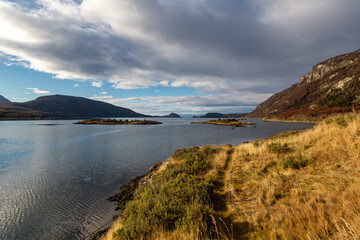 Panoramic landscape of a Patagonian lake in the Andes. No people, lake, mountains, sunset, tourism, travel, adventure, eco tourism, reflection, nature, wilderness, destination, outdoor, water, clouds