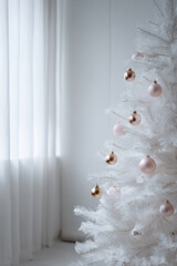 stunning white christmas tree adorned with delicate ornaments stands proudly against clean white background