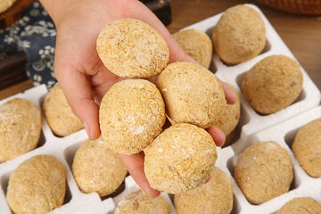 Fresh Homemade Golden Cookies in Hand with Baking Display