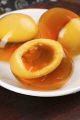 Soft-boiled eggs with golden runny yolks and loose egg whites on white plate