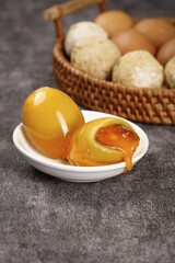 Golden Soft-Boiled Eggs with Runny Yolk and Fresh Eggs in Wicker Basket on Dark Surface