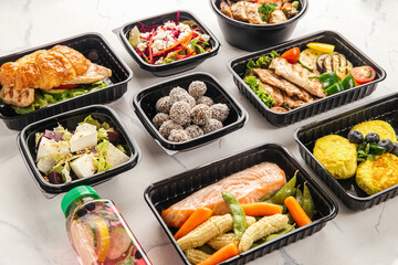 Healthy meal delivery with assorted dishes in plastic containers