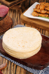 Traditional Chinese Flatbread Pancakes Stack on Wooden Board with Barbecue Food Background Zibo Cuisine
