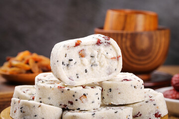 Homemade Nutty Fruit Confectionery Treats Stacked with Wooden Bowls for Healthy Tea Time Snacking