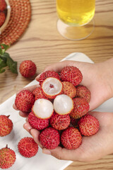 Fresh Lychee Fruits in Hands - Sweet Tropical Flavor with Red Skin and Translucent Flesh