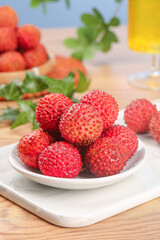 Fresh Red Lychees from Lingshan Zengcheng China on White Plate with Tropical Fruit Display