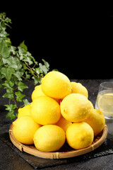 Fresh Yellow Lemons in Wicker Basket with Lemonade Glass - Summer Citrus Fruit Display
