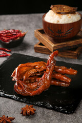 Marinated Duck Feet with Spicy Soy Sauce and Asian Ingredients on Black Slate