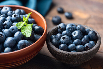 Fresh blueberries in bowl closeup view, summer berry harvest