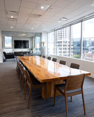 Spacious modern conference room bathed in natural light overlooking city buildings