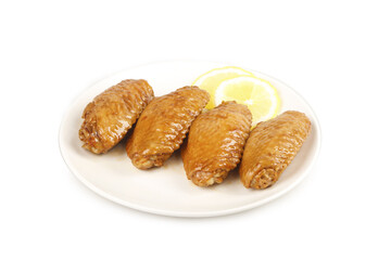 Salt-Baked Chicken Wings with Lemon on White Plate Against White Background