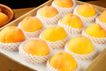Fresh Sweet Yellow Peaches in Protective Packaging Ready for Market Distribution