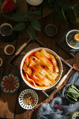 Handmade potato noodles in hot spicy broth traditional Asian cuisine wooden table setting