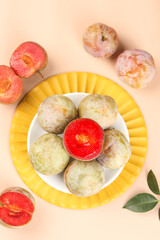 Fresh Ripe Plums on Yellow Plate - Healthy Organic Stone Fruit Display for Cooking and Nutrition