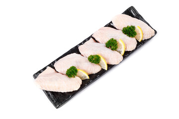 Raw Chicken Wings with Lemon and Parsley on Black Tray White Background