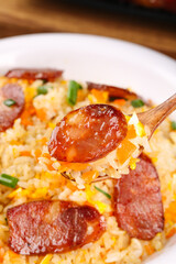 Fried Rice with Sausage on Wooden Spoon - Asian Cuisine Dish with Vegetables