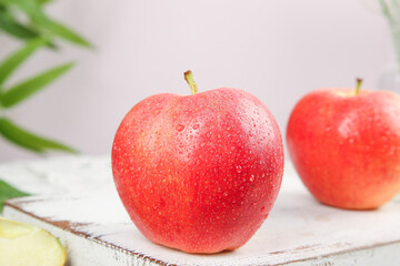 Fresh Red Apples with Water Droplets on Rustic White Wood Surface