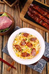 Fried Rice with Chinese Sausage and Vegetables on Wooden Table