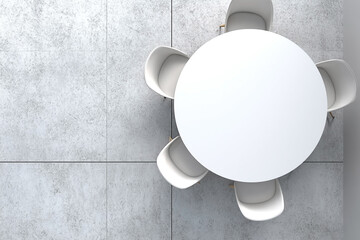 Minimalist modern dining space with white round table and chairs on grey tile floor