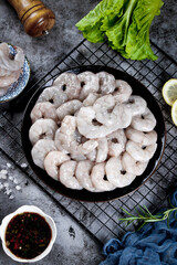 Fresh Raw Jumbo Shrimp Seafood Ingredients with Lettuce and Lemon on Kitchen Counter