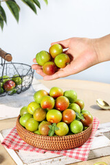 Fresh Ripe Plums in Wicker Basket on Rustic Wooden Table - Healthy Organic Stone Fruit Collection