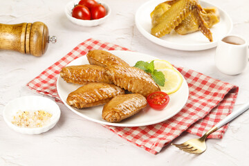 Salt-Baked Chicken Wings with Lemon and Tomatoes on Checkered Napkin