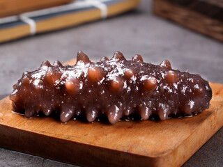 Raw Sea Cucumber on Wooden Board - Exotic Marine Delicacy for Asian Cuisine