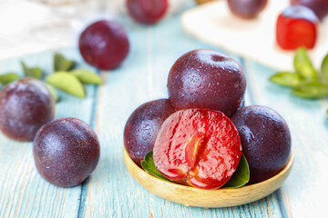 Fresh Red Flesh Plums Ready to Pick in Wooden Bowl - Ripe Stone Fruit Display