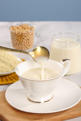Soy Milk Being Poured into Cup with Soybean Powder - Healthy Vegan Dairy Alternative